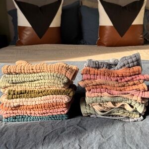 Stack of Multicolor Bibs and Burp Cloths